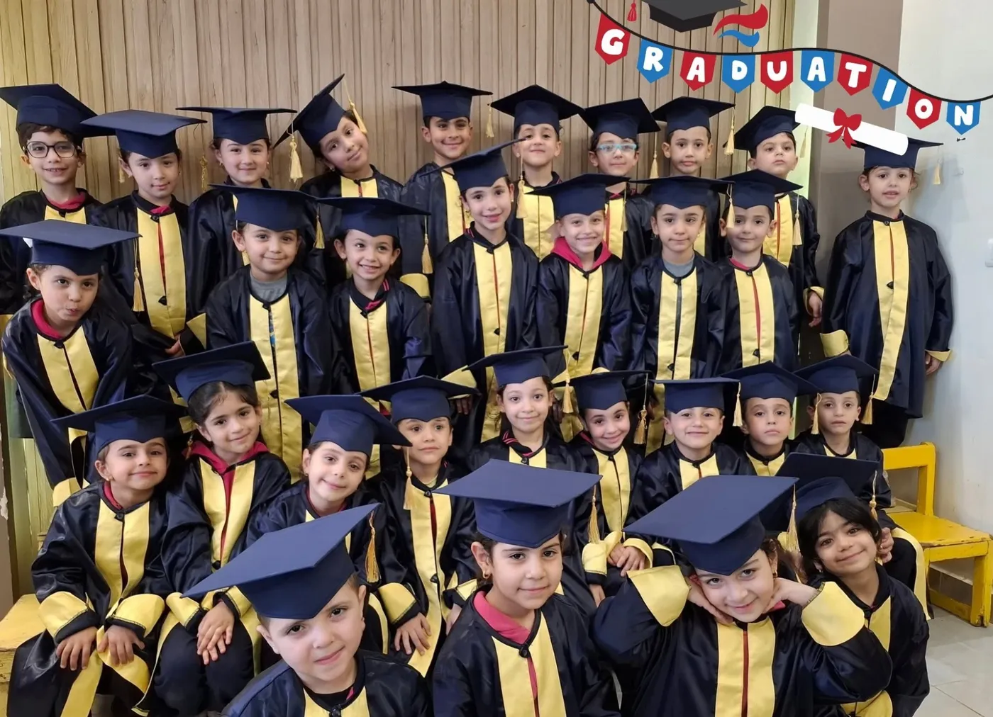 KG2 students in graduation caps and gowns
