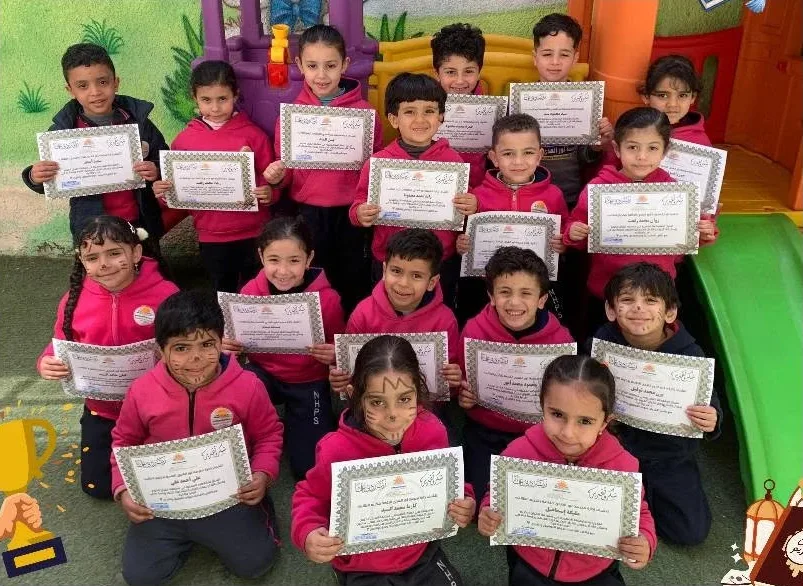 Kindergarten children holding certificates in the school playground